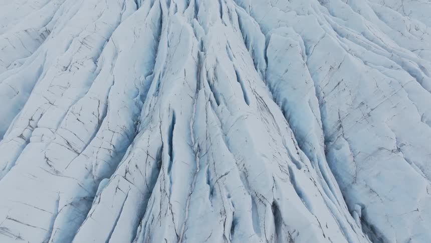 Panorama of a mountain with cracks covered in snow and ice during the day