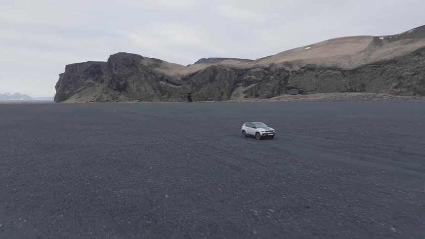 The car drives through the desert