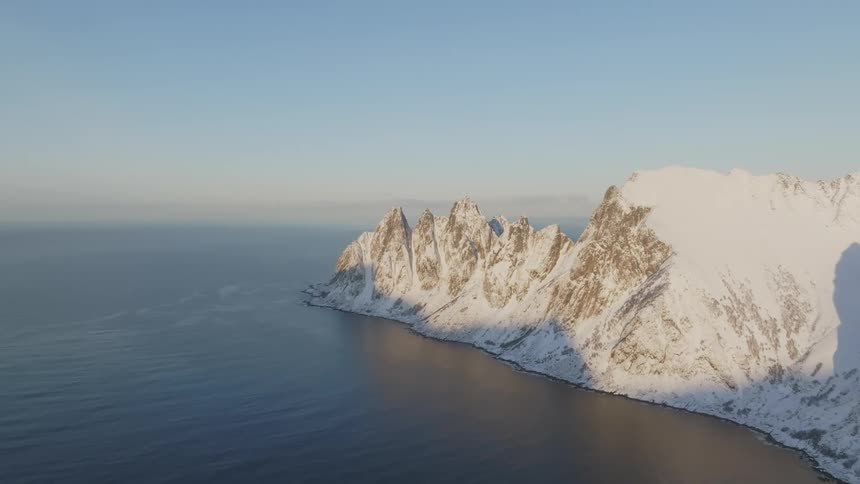 A high mountain promontory extends into the ocean