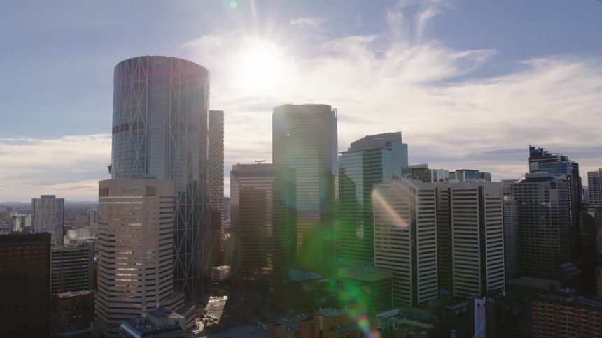 Aerial panorama of modern mirrored buildings in a metropolis with sunlight reflection during the day
