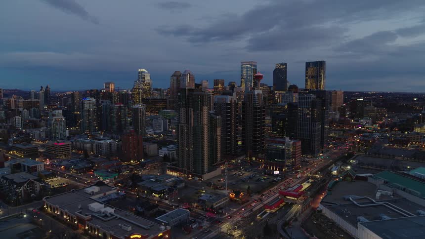 Aerial panorama of a dark cloudy sky overlooking a metropolis with skyscrapers and traffic