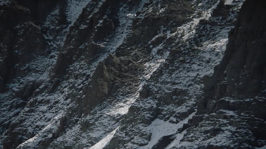 Mountainous and rocky range with erosion and snow