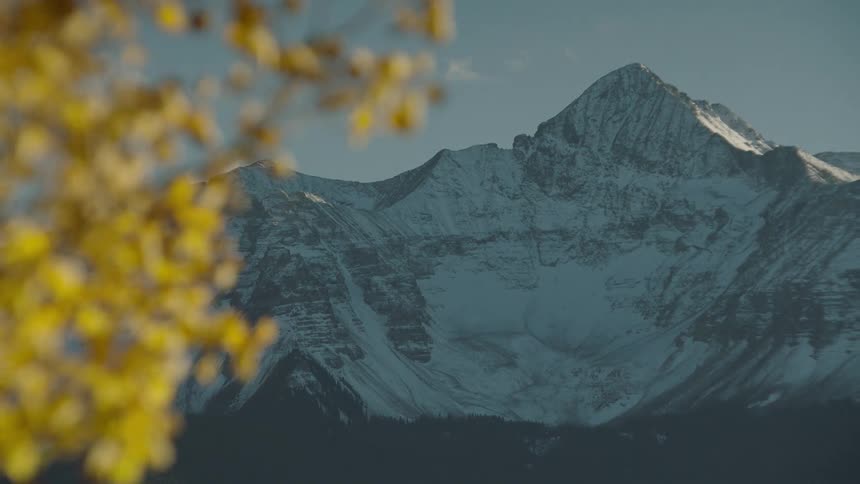 A snowcapped mountain peak under a clear blue sky