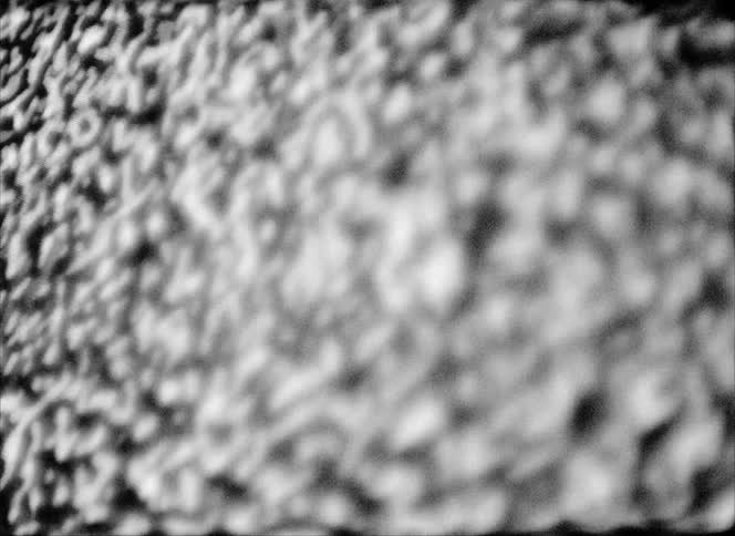 A glass display screen shows only static that flickers very rapidly