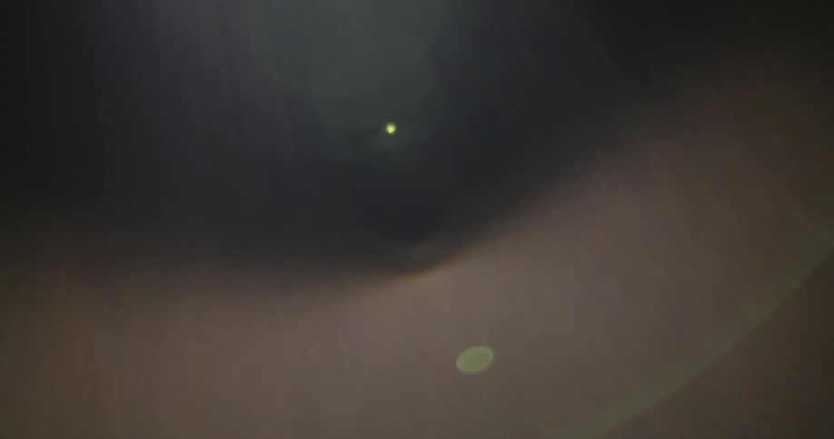 Extreme closeup of an iris of an abstract eye with reflection of lights