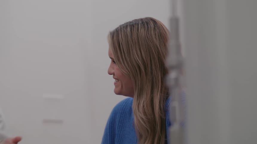 A doctor and a patient laugh while talking