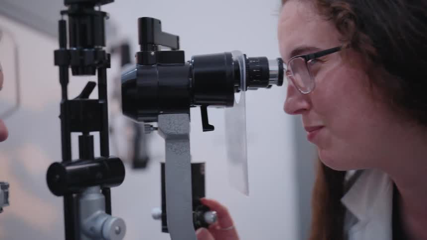 Ophthalmologist conducting specialized eye examination using a slit lamp biomicroscope