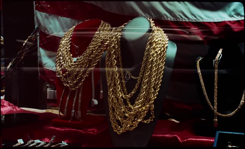 A display of gold necklaces in a jewelry store window