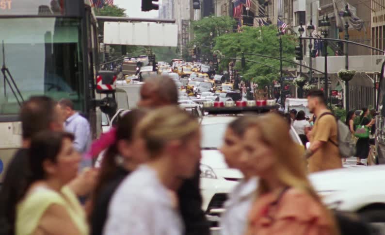 Street of a busy metropolis with vehicle and pedestrian traffic