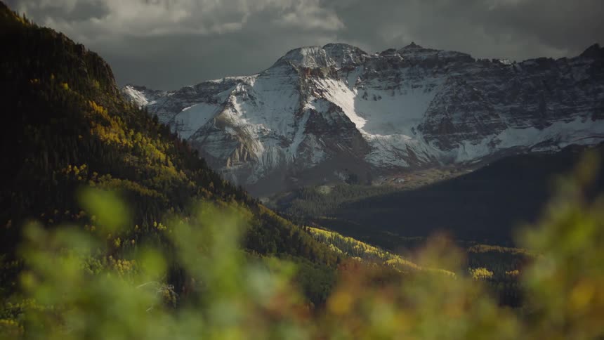 A rugged mountain peak with snow in the wilderness