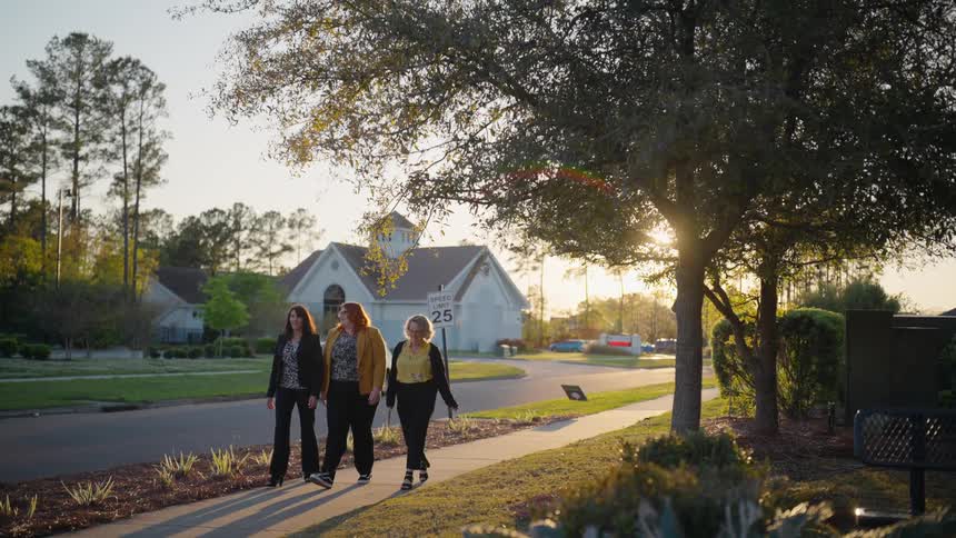 Friends walk on the sidewalk together
