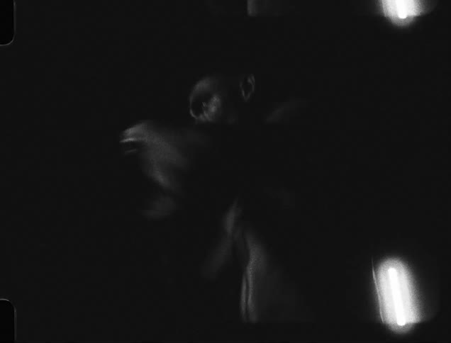 Portrait of a man without a shirt punching the air in boxing movements