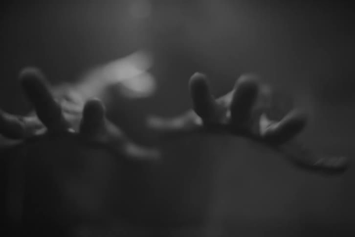 Closeup of a mans hands opening and closing indoors
