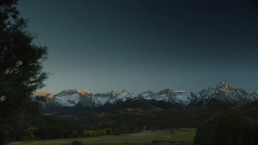 Mountain range with snowcapped peaks at dusk