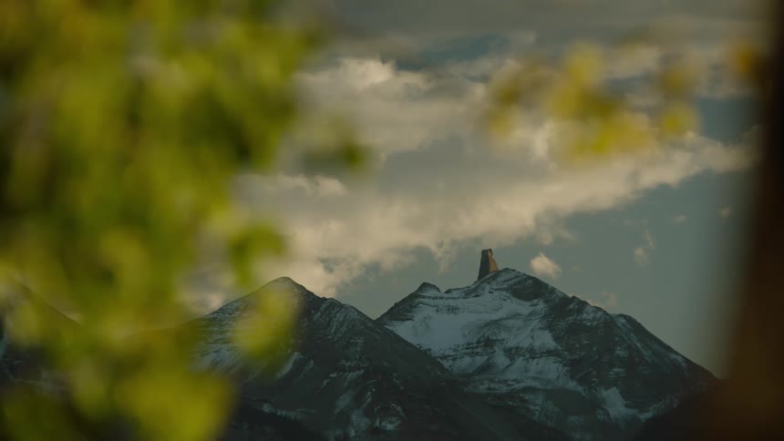 Mountainous landscape of snowcovered cliffs at cloud level
