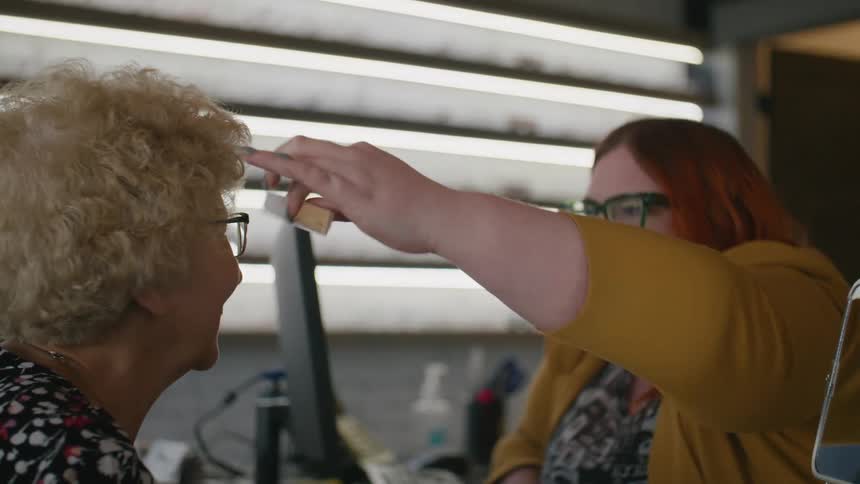 An ophthalmologist gives a patient a simple eye test