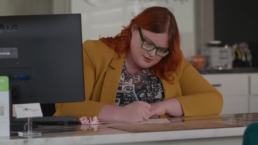 Secretary takes notes on the front desk