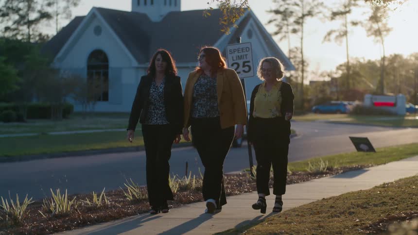 A group of friends walking on the neighborhood at sunset