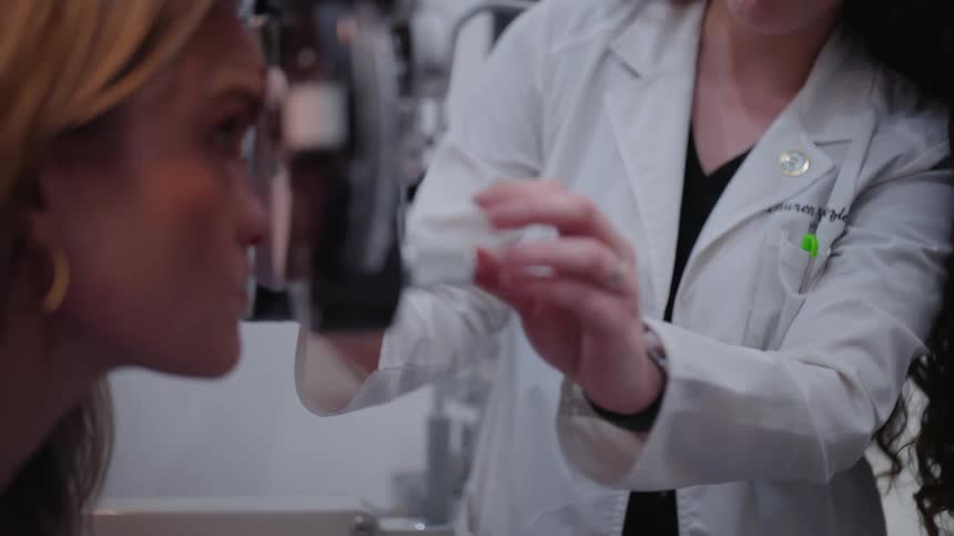 A person undergoing an eye examination with a phoropter