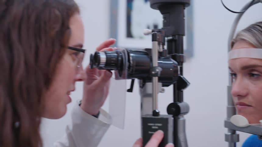 Doctor talking to her patient who is framed with her face facing a viewing lens
