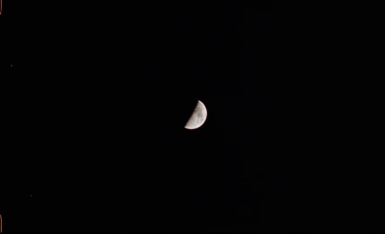 Crescent moon against black night sky