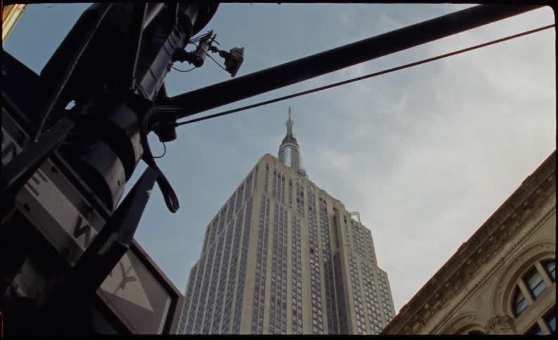 Upward view of the chrysler building on a blue sky day with clouds