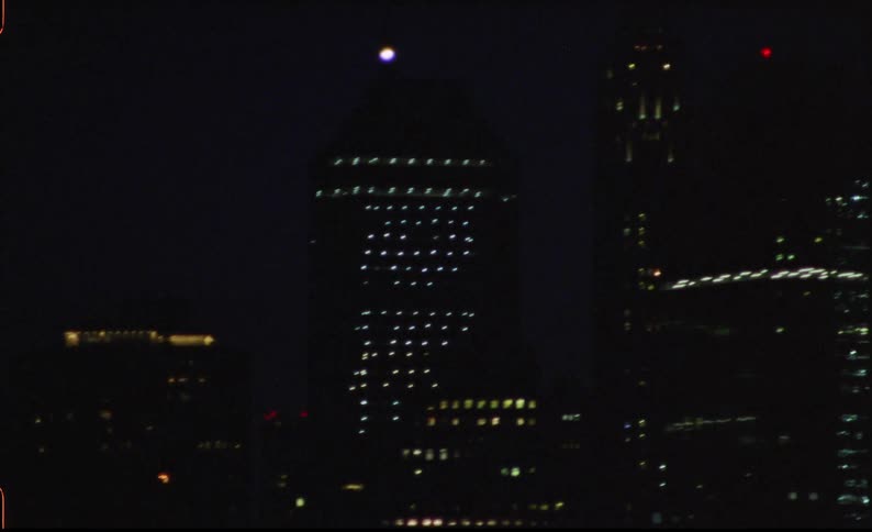Metropolis with skyscrapers and a tower illuminated at night