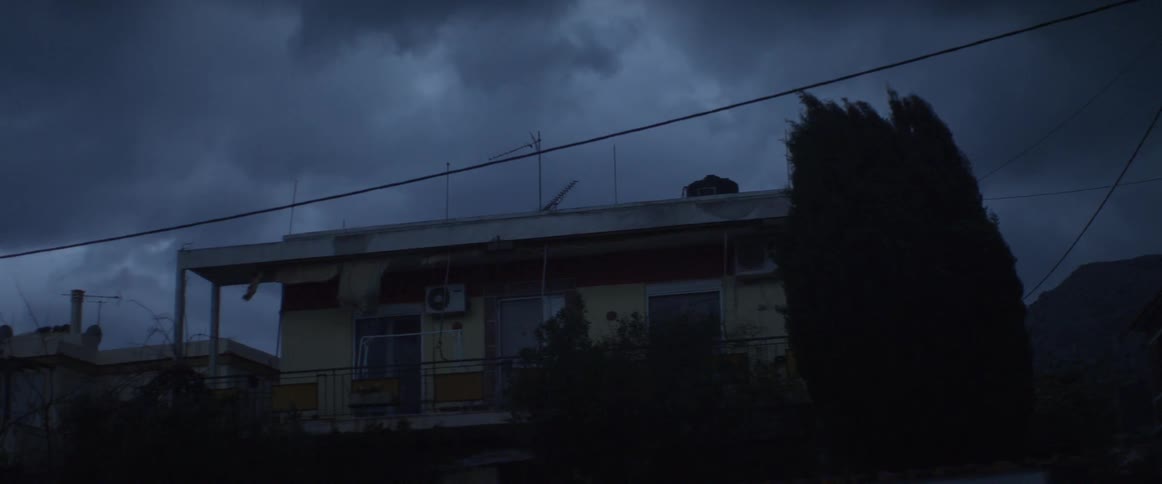Clouds passing over a home on a stormy evening