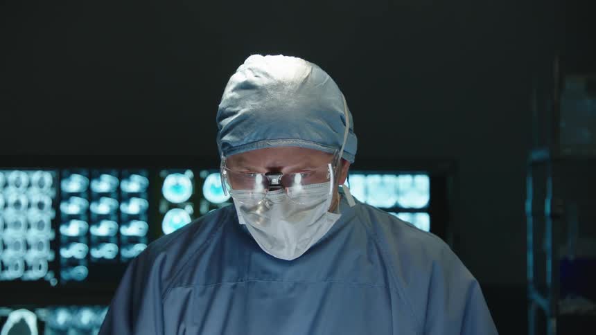 Portrait of a male surgeon with a mask and specific clothes and images of a brain in the background