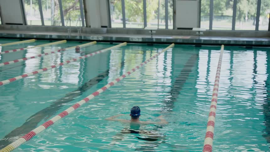 A swimmer is floating in the middle of the pool