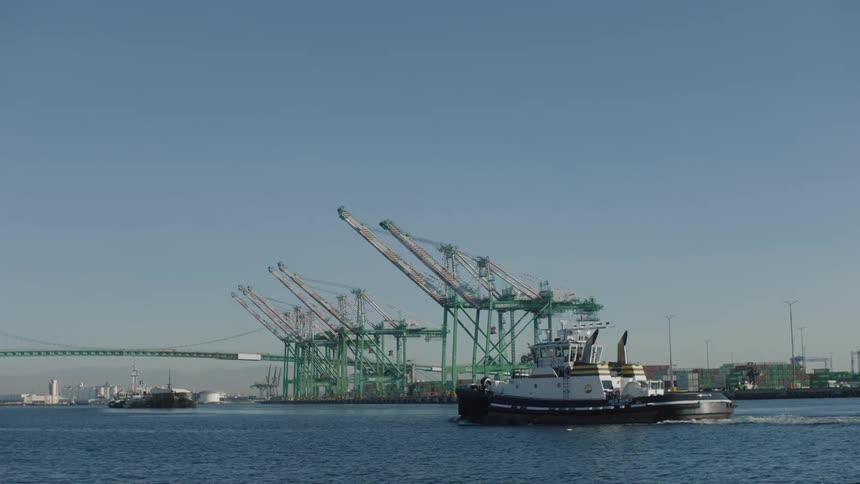 A barge travels past the harbor