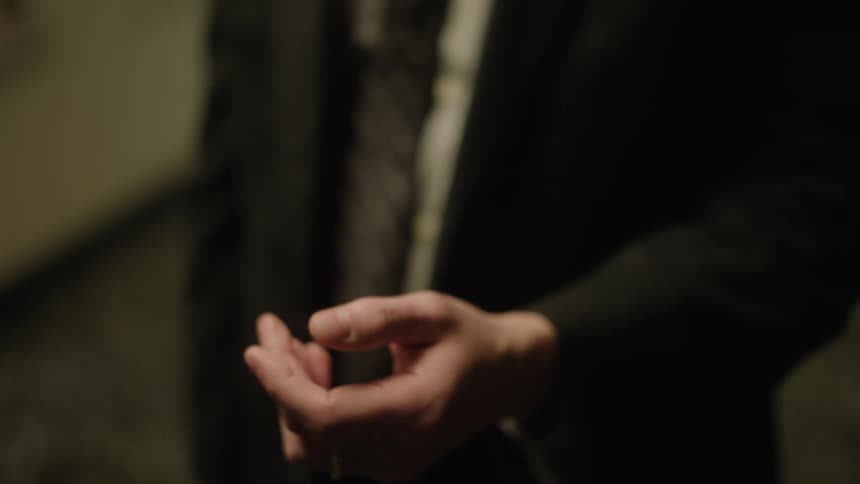 A man hands a plate of food to someone who walks away