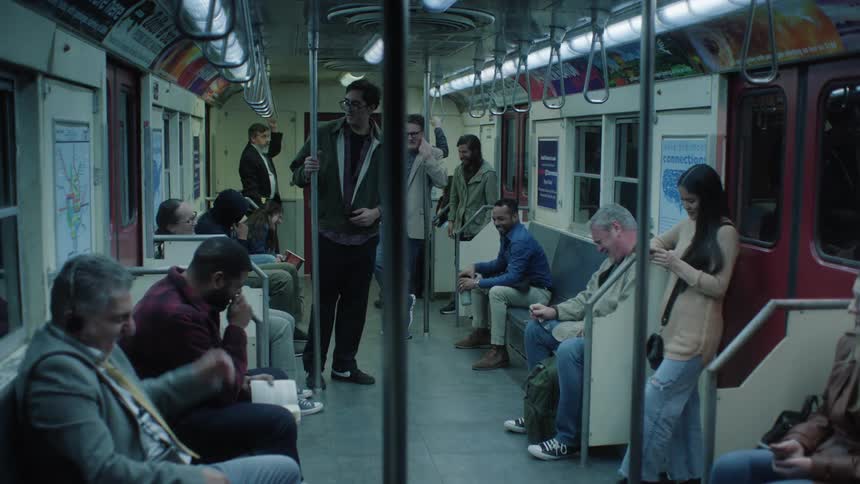 Commuters laugh at a man who is looking around ashamedly in the subway