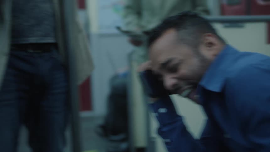 Friends sitting on train benches laughing