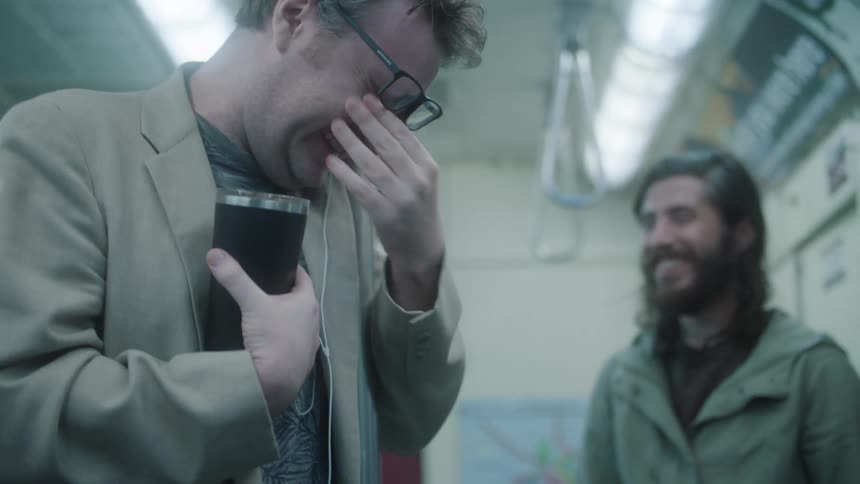 Men inside a train laughing