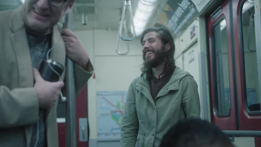 Men inside a train carriage laughing