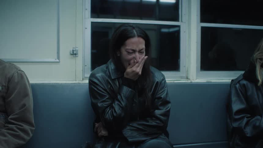 Woman sitting on a train bench crying