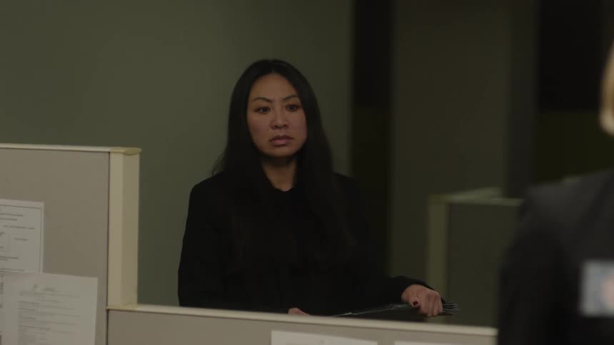 Portraits of a woman with a suspicious facial expression while standing in an office room