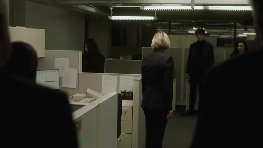 People in an office interact with one another