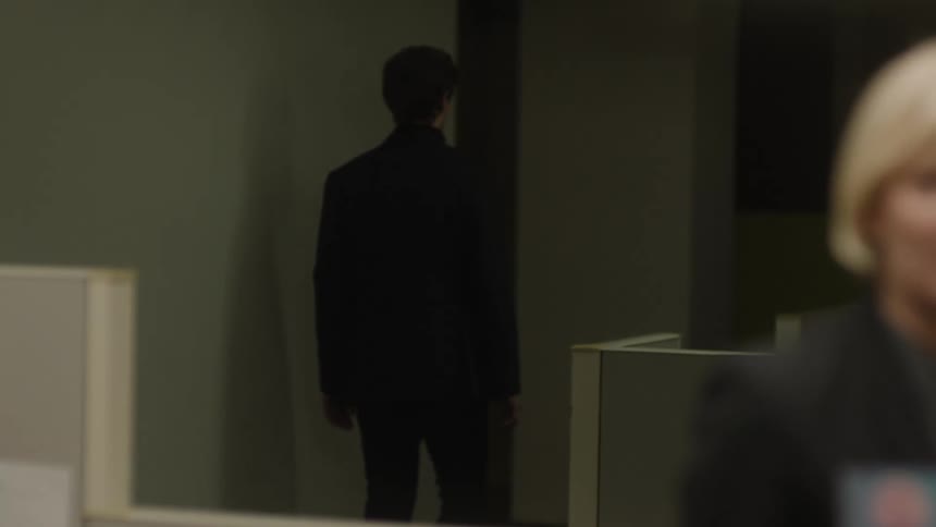 An employee leaves an office while another person is talking