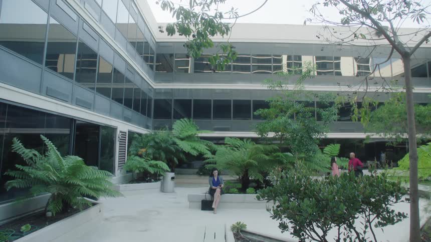 Coworkers sit in the courtyard outside the office building