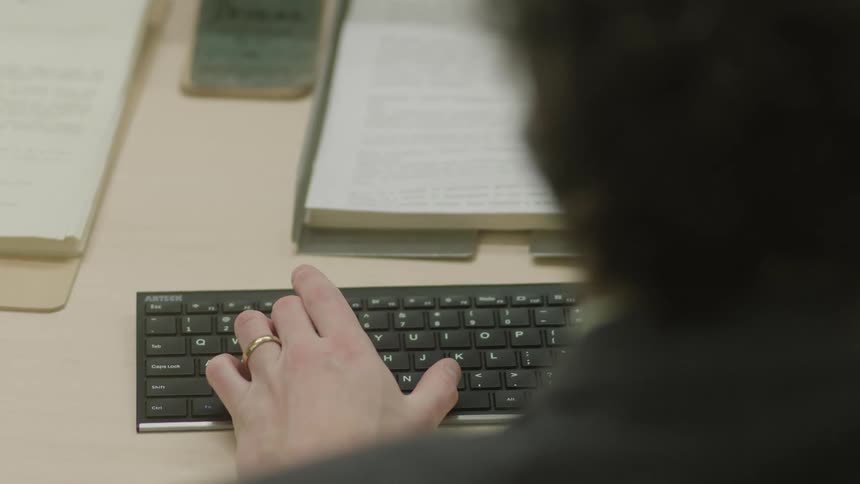 A man typing on a computer keyboard