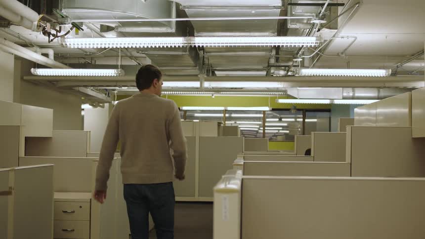 Man walking down an office hallway