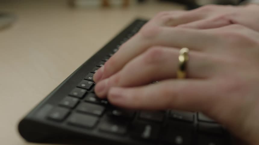 A close of clip of a persons hand typing