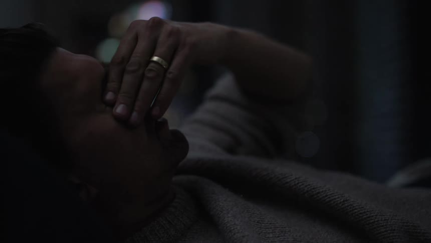 A man is restless as he lays in bed