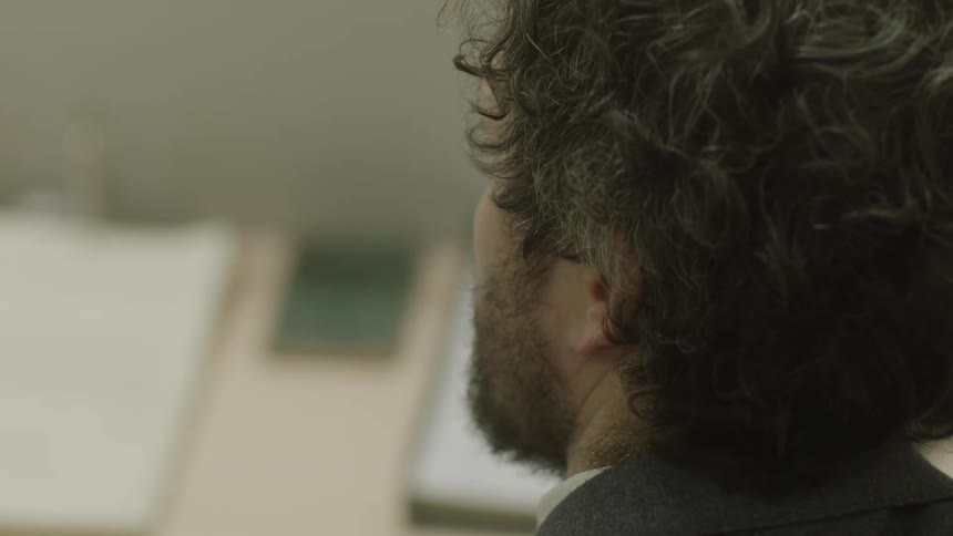 Back view of a mans head indoors during the day