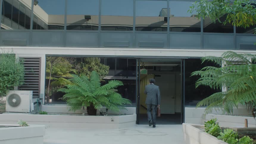 A worker enters the office building