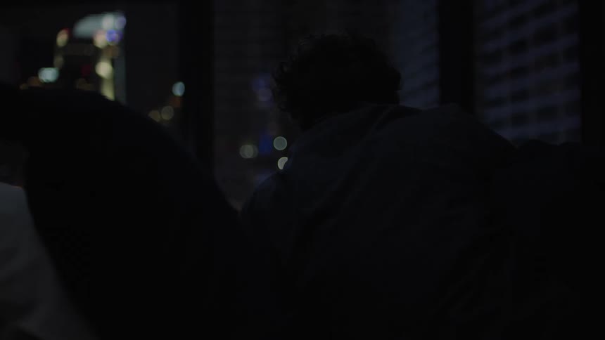 A person is laying down in the dark room