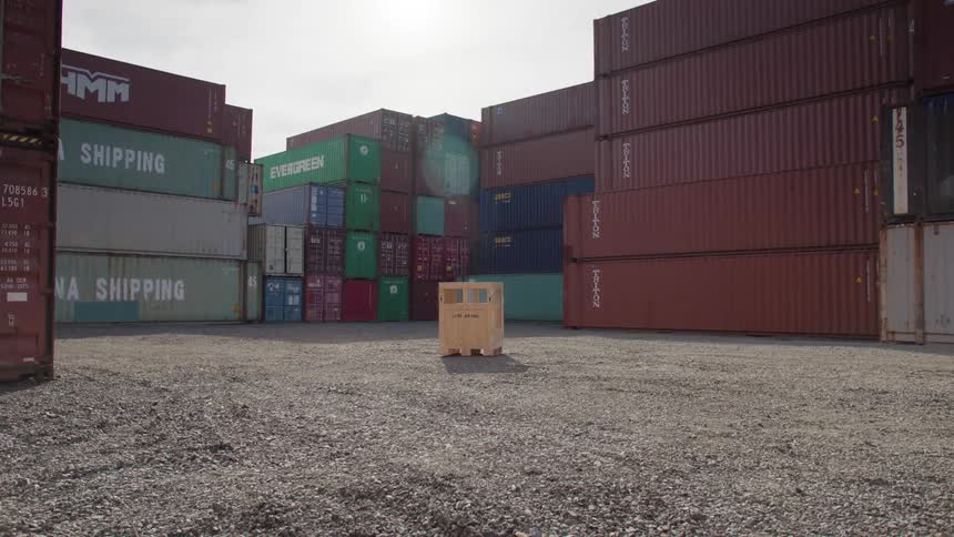 Wooden box in the center of containers in an openair location