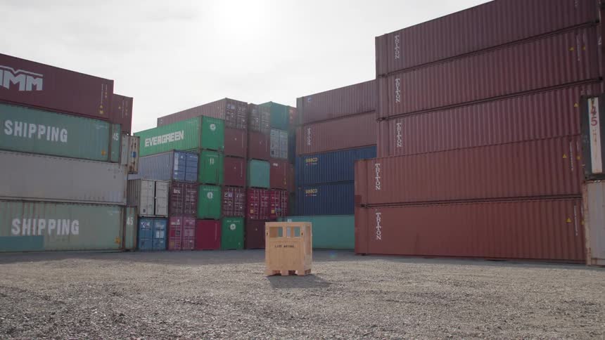 Wooden box in the center of an environment with containers around it